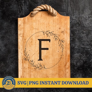 May include: A wooden sign with a rope handle features a black and white floral wreath with the letter "F" in the center. The sign is on a black background. SVG | PNG INSTANT DOWNLOAD.