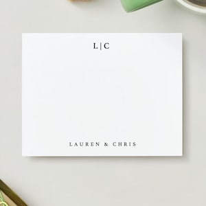 May include: White notepad with the text "L|C" and "LAUREN & CHRIS" printed on it.