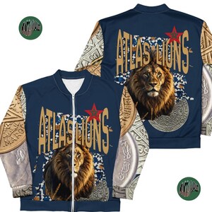May include: Navy blue bomber jacket with a lion graphic and the text "ATLAS LIONS". The jacket has a zip closure and a red star emblem. The sleeves feature a pattern of coins and Arabic script.