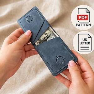 May include: A blue leather wallet with visible stitching and two circular snap closures. The wallet features two angled card slots and a central compartment containing a one hundred dollar bill. Two circular icons indicate PDF PATTERN and US LETTER.