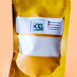 May include: A gold metallic pouch with a clear window, containing a white substance. A white label displays the text "Kahlans Garden" and social media information. The pouch is sealed and has a glossy finish.