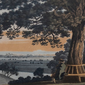 May include: An antique print depicting a landscape scene with a large tree in the foreground. A person sits on a bench beneath the tree, looking out at a distant town. The sky is a soft orange and blue.