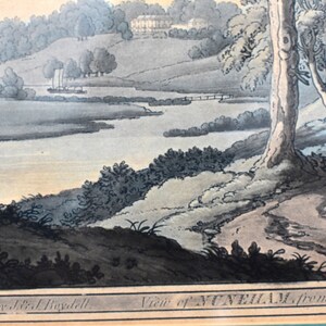 May include: An antique print depicting a view of Nunham from the woods. The print is in black and white with hand-painted watercolor accents. The image shows a river winding through a wooded landscape with a house in the distance.