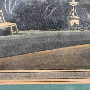 May include: An antique print of a garden scene with a bench, a statue, and trees. The print is in black and white with a brown border. The text at the bottom reads "Gallery Pall. Mall & Cheapside. J.C. Stadler sculp."