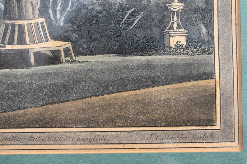 May include: An antique print of a garden scene with a bench, a statue, and trees. The print is in black and white with a brown border. The text at the bottom reads "Gallery Pall. Mall & Cheapside. J.C. Stadler sculp."