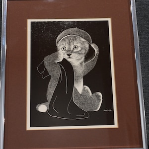 May include: A black and white illustration of a kitten wearing a hat and holding a piece of fabric. The kitten is looking to the left. The illustration is signed "CHAPLAN."