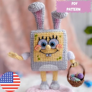 Puede incluir: Patrón de crochet para un personaje de Bob Esponja vestido de conejito de Pascua. El patrón incluye instrucciones para hacer el cuerpo, la cabeza, las orejas del personaje y una cesta de huevos de Pascua. El patrón está disponible para descargar en PDF.