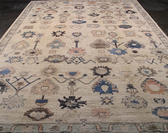 May include: A beige rug with a traditional Persian design featuring intricate patterns in shades of blue, brown, and pink.