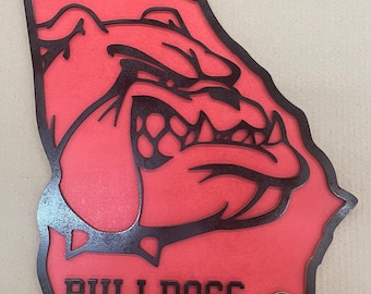 May include: A red and black wooden cutout of the state of Georgia with a bulldog's head and the word "BULLDOGS" at the bottom.