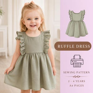 May include: A young child wearing a sage green ruffle dress smiles at the camera. The dress has ruffled sleeves and a gathered skirt. The image also includes a graphic of the dress and text that reads "RUFFLE DRESS" and "SEWING PATTERN 2 - 4 YEARS A4 PAGES."