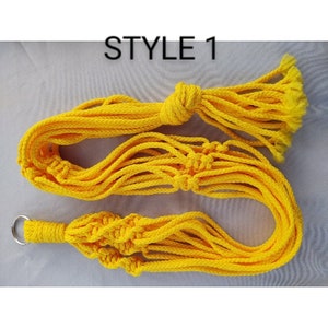 May include: Yellow macrame plant hanger with a loop at the top. The hanger is made of thick cotton rope and has a knotted design. The text "STYLE 1" is visible in the image.