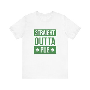 May include: White t-shirt with a green square graphic that says "STRAIGHT OUTTA PUB" with shamrocks on either side of the word "PUB".