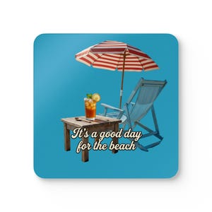 May include: A coaster with a beach scene. It features a red and white striped umbrella, a wooden table with a drink, a beach chair, and the text "It's a good day for the beach" on a blue background.