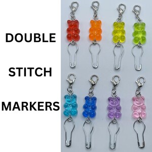 May include: Set of ten colorful gummy bear stitch markers with safety pins. The markers are in red, orange, yellow, green, blue, light blue, purple, pink, and clear. The text "DOUBLE STITCH MARKERS" is visible in the image.