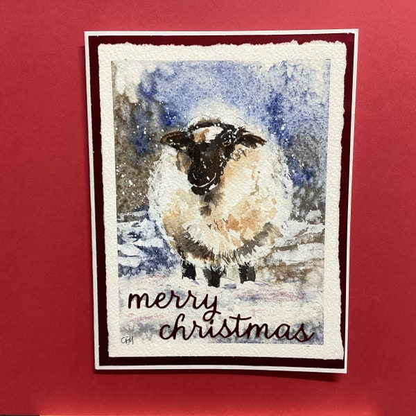 pdf download for Watercolours With Caroline's lesson of a Christmas card Snowy Sheep. Lesson plans and traceable line drawings.