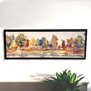 May include: A long, horizontal abstract landscape painting with a black frame. The painting features a row of trees in various shades of green, yellow, blue, and red, with a light blue and yellow sky above. The trees are painted in a loose, impressionistic style, with visible brushstrokes. The painting is set against a white background.
