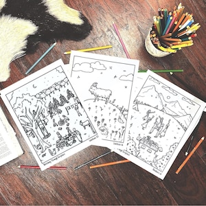 May include: Three black and white coloring pages with biblical scenes, titled "Sketching Through Scripture", are arranged on a wooden surface. Colored pencils in a small container and scattered around the pages. A faux fur rug is in the background.
