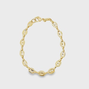 May include: A gold-toned chain bracelet featuring a series of interconnected, polished oval links. The bracelet is constructed with a secure lobster claw clasp mechanism at the top, creating a continuous circular loop of metallic, reflective links.
