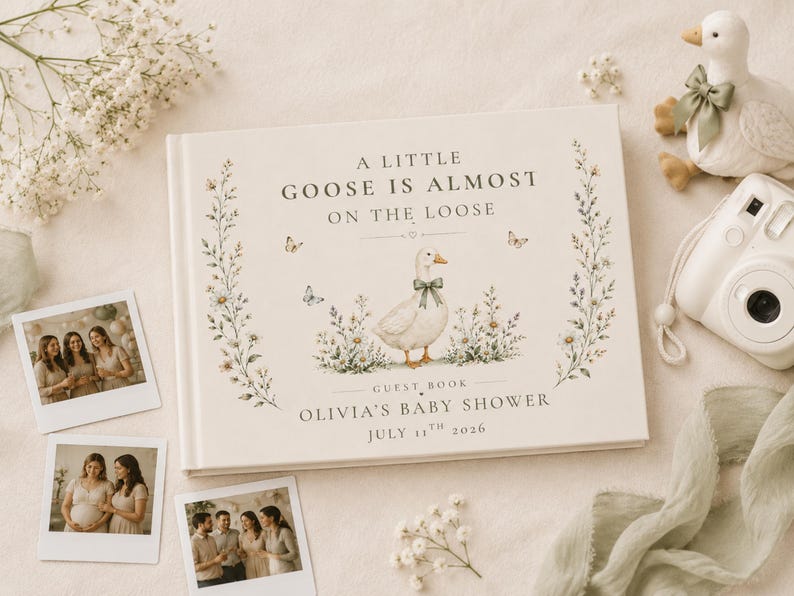 May include: A rectangular guest book with a cream cover featuring a central illustration of a goose wearing a green bow, surrounded by wildflowers and butterflies. The text reads A LITTLE GOOSE IS ALMOST ON THE LOOSE, GUEST BOOK, OLIVIA'S BABY SHOWER, JULY 11TH 2026.