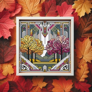 May include: A framed cross-stitch design featuring a stylized art deco scene with three trees in shades of yellow, pink, and green. The trees are set against a geometric background with a light blue sky and a brown ground.