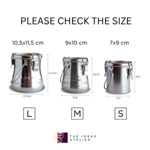 May include: Three stainless steel paint containers with lids and handles. The containers are labeled with their sizes: 10.5 x 11.5 cm (L), 9 x 10 cm (M), and 7 x 9 cm (S).
