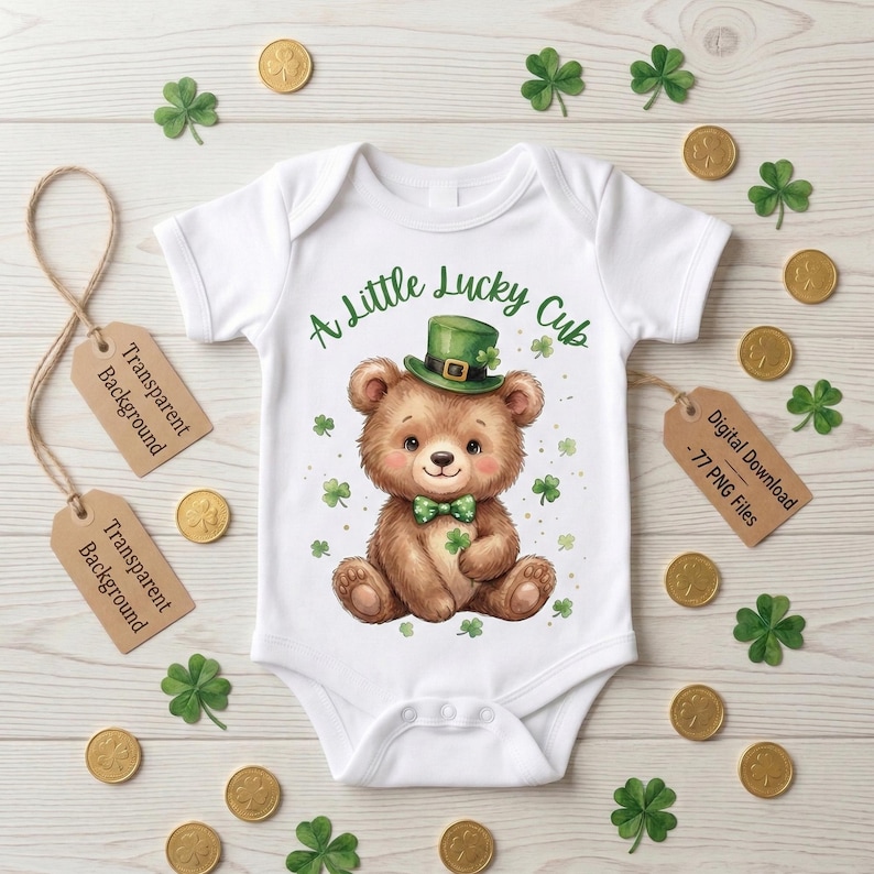 May include: White baby bodysuit featuring a cartoon bear in a green hat and bow tie, with shamrocks and gold coins. The text says "A Little Lucky Cub". A St. Patrick's Day design.
