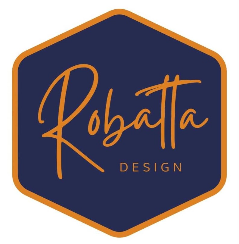May include: A navy blue hexagonal logo with an orange outline. The logo features the word "Robatta" in a handwritten orange font and the word "DESIGN" in a smaller orange font below.