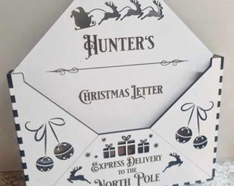 May include: White wooden Christmas letter box with a black and white checkered border. The box has a slot for letters and a flap that says "Hunter's Christmas Letter" and "Express Delivery to the North Pole".
