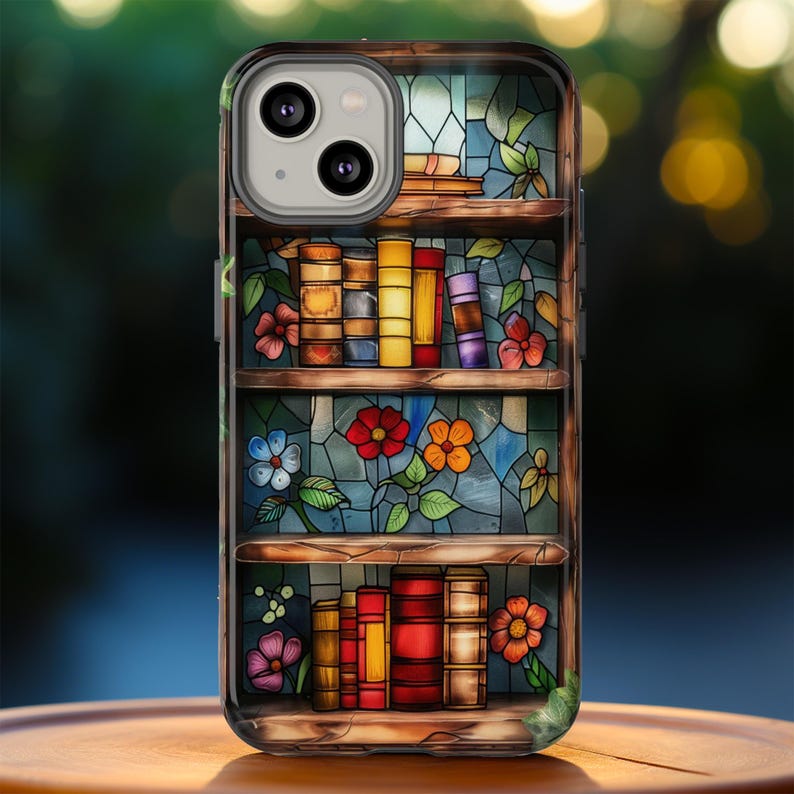 May include: A stained glass phone case with a bookshelf design. The case features a colourful stained glass pattern with books, flowers, and a wooden shelf. The case is designed for a smartphone with a camera lens cutout.