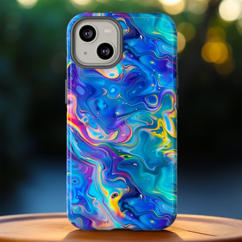 May include: A smartphone case with a vibrant, abstract design. The case features a swirling pattern of blues, purples, yellows, and pinks, creating a colorful, marbled effect. The case has a camera cutout and button placements.
