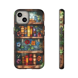 May include: A phone case featuring a stained glass design of a bookshelf with books and flowers. The case is black with a clear back.