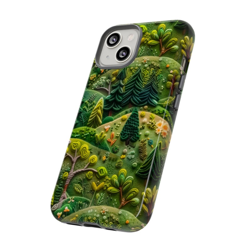 May include: A green, blue and yellow phone case with a whimsical illustration of a forest scene. The case features a variety of trees, flowers and other foliage.