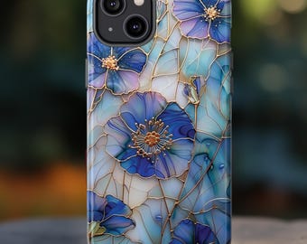 May include: A smartphone case featuring a floral design. The case has a blue and white background with blue flowers and gold-colored outlines. The case has a glossy finish and a camera cutout.