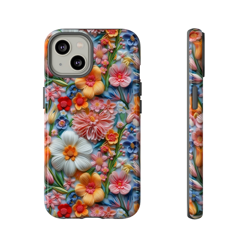 Może przedstawiać: Etui na telefon z kolorowym wzorem kwiatowym. Kwiaty są wykonane z papieru i mają efekt 3D. Etui jest kompatybilne z iPhone'em 13 Pro.