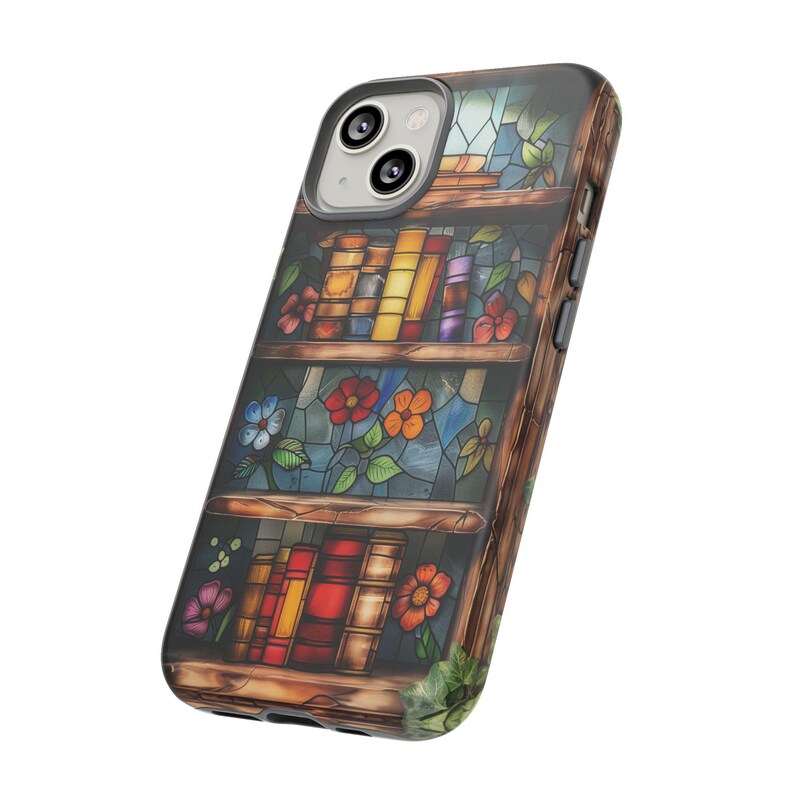 May include: A phone case featuring a stained glass design of a bookshelf with books and flowers. The case is made from a clear material and has a black border.