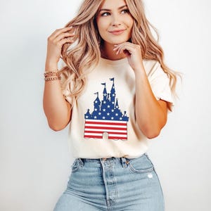 Castle silhouette with American flag design in red, white, and blue on a t-shirt.