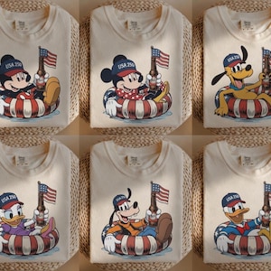 Mickey Mouse in a patriotic theme with "USA 250" on a hat, holding a flag on a t-shirt.