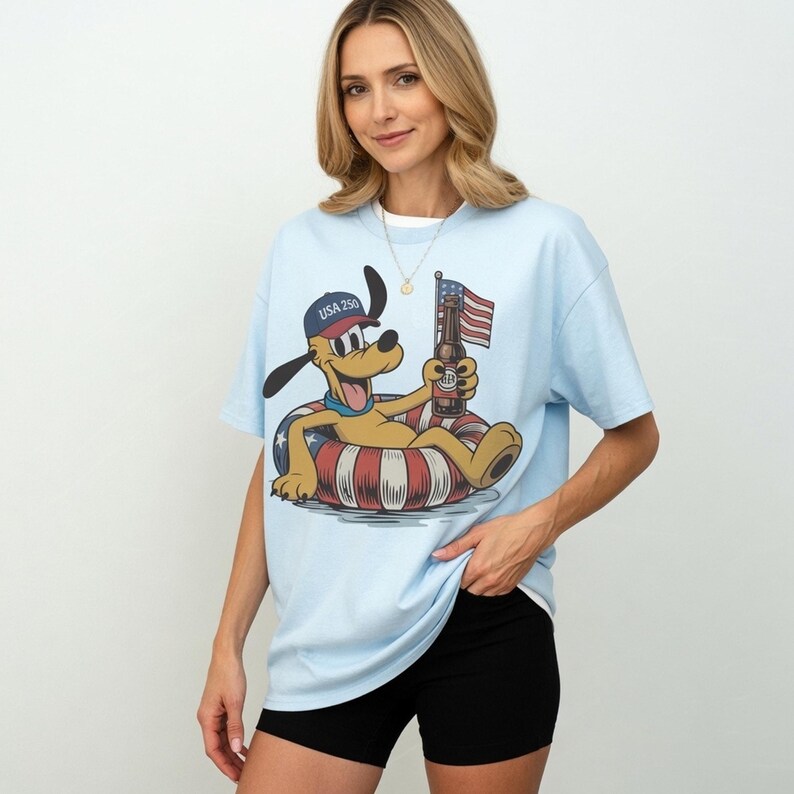 Donald Duck in patriotic attire with "USA 250" text holding a flag on a t-shirt.