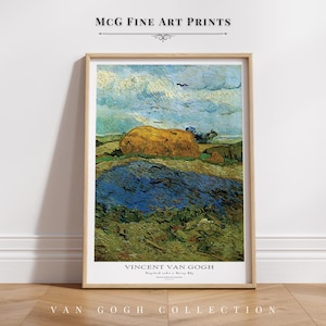 May include: A framed print of a landscape painting, depicting a golden haystack beneath a cloudy sky. The artwork, part of the Van Gogh Collection, has a blue and green foreground. The text "MCG FINE ART PRINTS" is at the top.