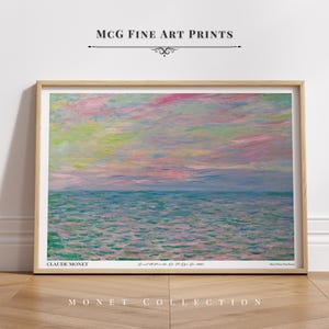 Peut inclure: Une estampe d'art de "Mer à Pourville, de 0 à 5 heures, S." de Claude Monet. La peinture représente un paysage marin avec un ciel rose et bleu et une mer verte et bleue. L'estampe est encadrée dans un cadre en bois clair.