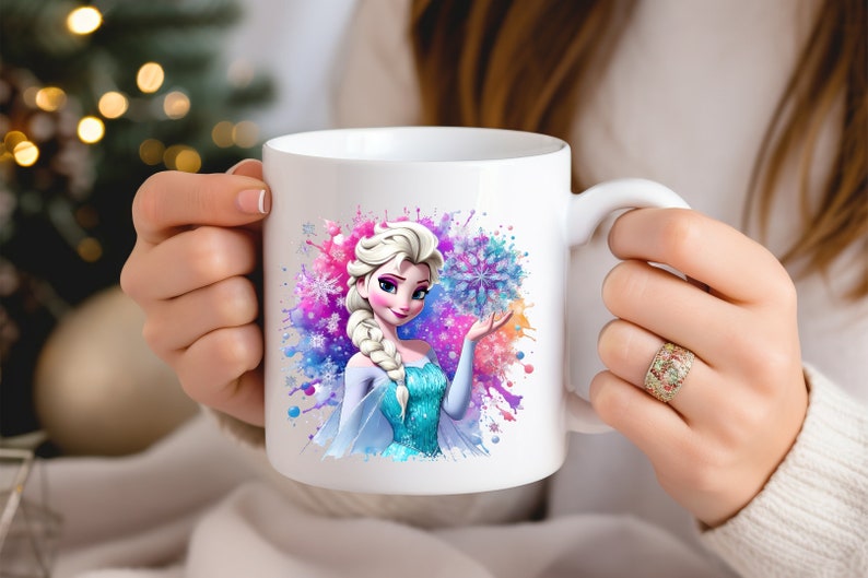 May include: White ceramic mug with a colorful watercolor design featuring Elsa from Frozen. Elsa is holding a snowflake and is surrounded by blue, pink, and purple watercolor splatters.