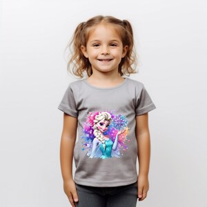 May include: A gray short-sleeved t-shirt with a colorful graphic print of Elsa from Frozen. The graphic features Elsa in her ice queen dress with a snowflake in her hand. The background is a watercolor-style design with blue, purple, and pink colors.