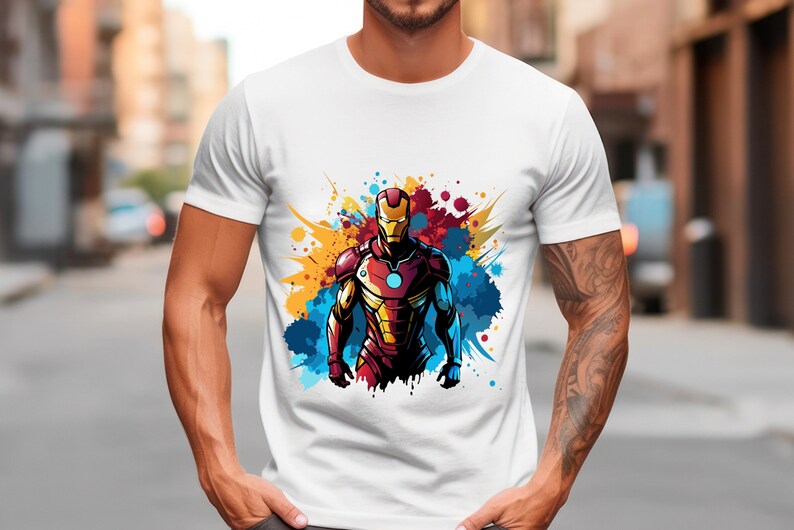 May include: White t-shirt with a colorful graphic of Iron Man in a superhero pose with a red, yellow, and blue paint splatter background.