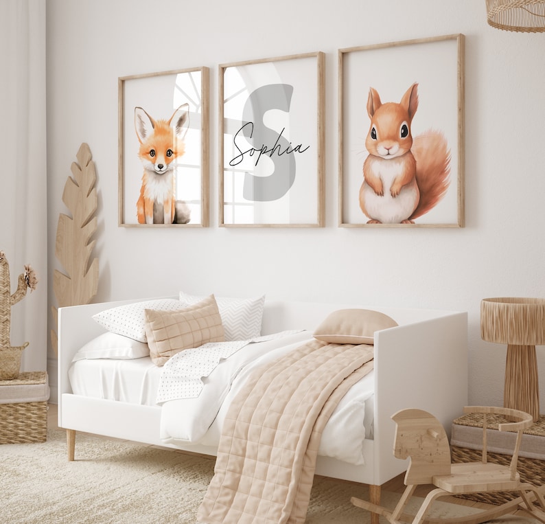 May include: Three framed prints with a white background. The left print features a cartoon fox, the middle print features the letter "S" and the name "Sophia" written in cursive, and the right print features a cartoon squirrel.