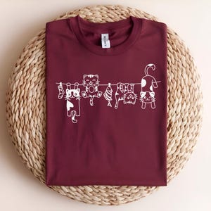 Funny Cat Shirt – Cute Cats on a Clothesline T-Shirt, Whimsical Kitty Graphic Tee, Cat Lover Gift, Playful Pet Parent Shirt for Her