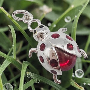 May include: A white ceramic mug with a black handle and the text "But First, Coffee" in a black, handwritten-style font. The mug is on a white surface.