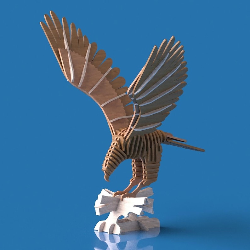 May include: A wooden eagle sculpture with outstretched wings, perched on a white base. The eagle is constructed from layered wood pieces, showcasing a detailed design. The wings are a light brown color, and the background is a solid blue.