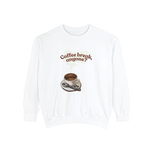 May include: White long-sleeved sweatshirt with a graphic of a coffee cup and the text "Coffee break, anyone?"