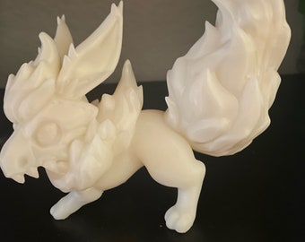 May include: A white, 3D printed figurine of a mythical creature with a fox-like body and a tail that resembles flames. The creature has a fierce expression and sharp teeth.