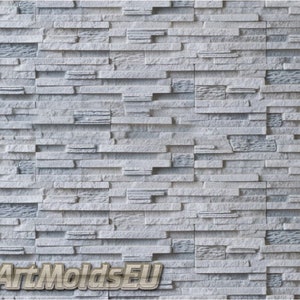May include: A close-up of a white textured wall made of stacked stone tiles. The wall has a rough, uneven surface and a slightly grey hue. The text "ArtMoldsEU" is visible in the bottom right corner of the image.
